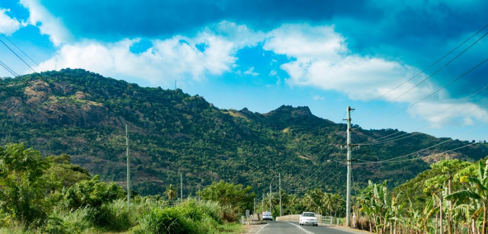 my-fiji-909908894-local-roads-with-mountains-in-distance-in-nadi