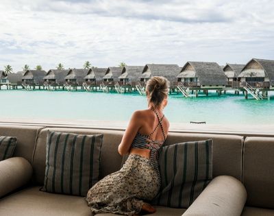 my-fiji-woman-overlooking-overwater-bures-at-Fiji-Marriott-Resort-Momi-Bay