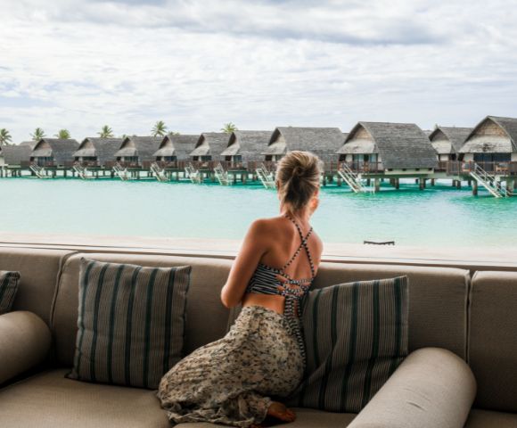 my-fiji-woman-overlooking-overwater-bures-at-Fiji-Marriott-Resort-Momi-Bay