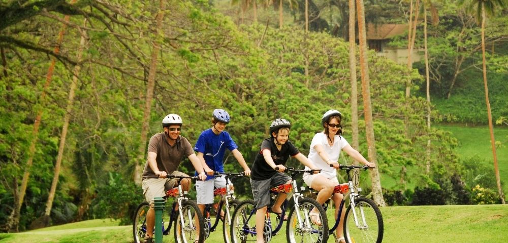 mother father and two sons enjoying a bike ride through the resort