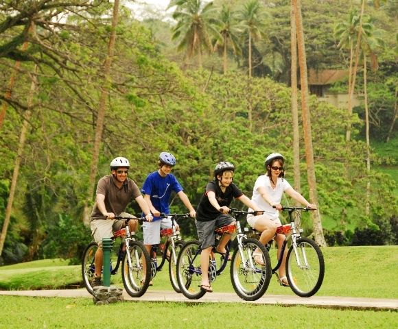 mother father and two sons enjoying a bike ride through the resort