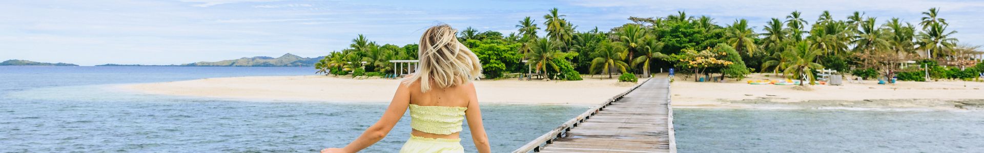 my-fiji-woman-in-bright-yellow-dress-running-down-jetty-of-malamala-bach-club