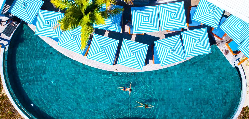 Aerial view of pool with people swimming at Malamala Beach Club in Fiji