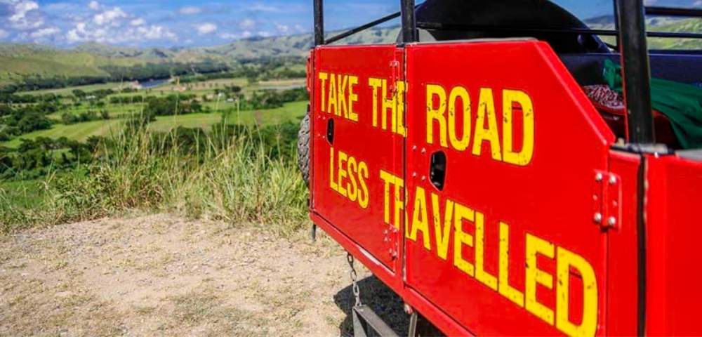 my-fiji-offroad-cave-safari-atv-safari-with-painted-sign-that-reads-take-the-road-less-travelled