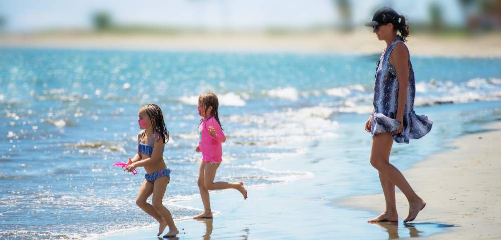 MYHOLIDAY-RADISSON-BLU-RESORT-FIJI-DENARU-ISLAND-FAMILY-ON-BEACH-RUNNING-INTO-OCEAN