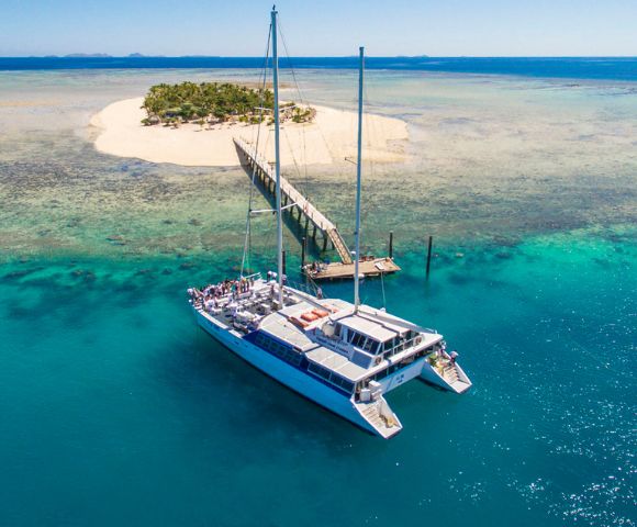 MYFIJI-Robinson-Crusoe-Island-Tours-Tivua-Island-Aerial-view-of-island-and-sail-boat-arriving-at-the-jetty