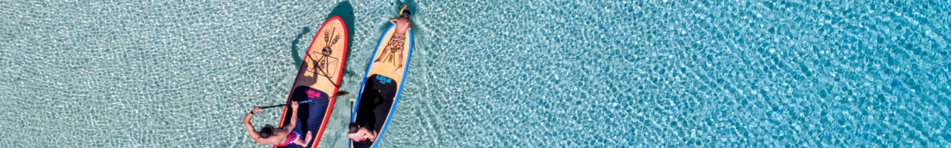 my-fjii-birds-eye-view-of-a-family-stand-up-paddleboarding-in-clear-water-in-fiji