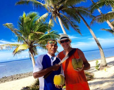 MY-HOLIDAY-Two-men-on-a-beach-undertaking-Coconut-Grating-at-Tambua-Sands-Beach-Resort