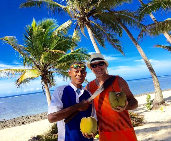 MY-HOLIDAY-Two-men-on-a-beach-undertaking-Coconut-Grating-at-Tambua-Sands-Beach-Resort