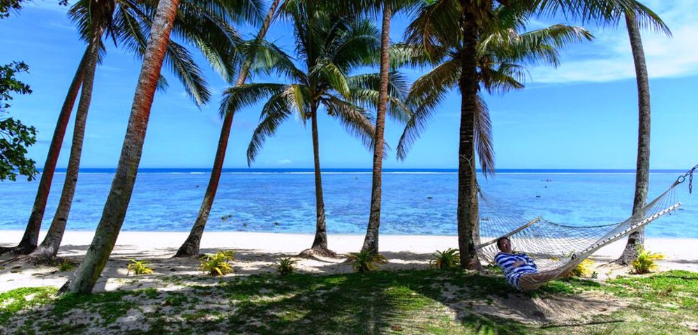 MY-HOLIDAY-Person-on-hammock-on-the-beach-at-Tambua-Sands-Beach-Resort