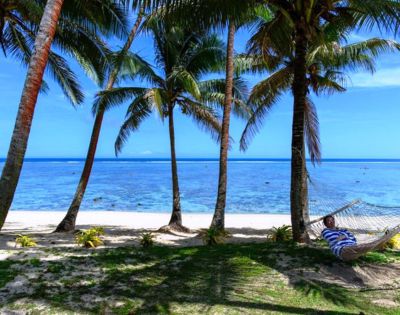 MY-HOLIDAY-Person-on-hammock-on-the-beach-at-Tambua-Sands-Beach-Resort