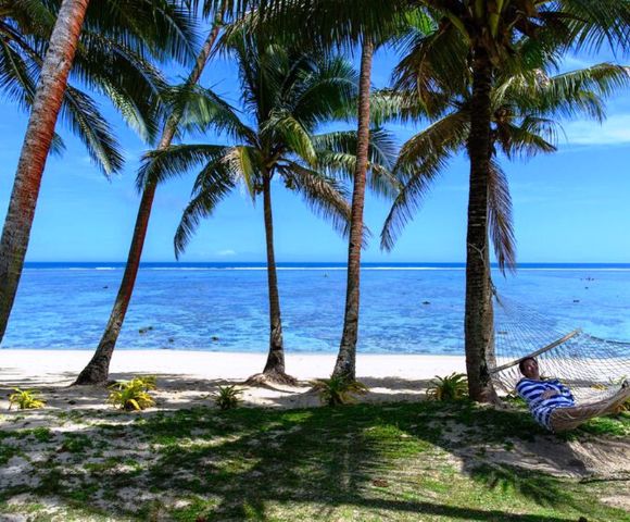 MY-HOLIDAY-Person-on-hammock-on-the-beach-at-Tambua-Sands-Beach-Resort