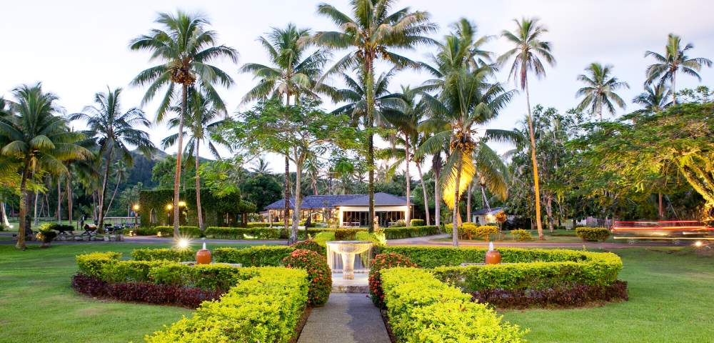 MYHOLIDAY-THE-NAVITI-RESORT-GARDEN-PATH-TO-WATER-FOUNTAIN-RESORT-IN-BACKGROUND