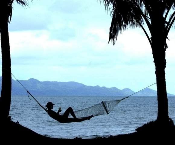 my-fiji-woman-relaxing-in-a-hammock-by-the-water-at-the-pearl-resort-spa-golf-course