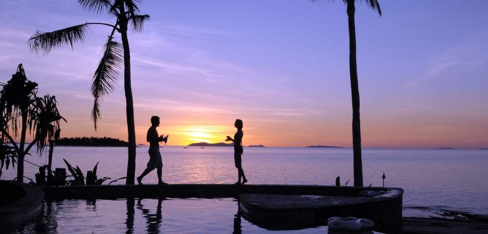 my-fiji-two-people-by-the-pool-at-sunset-at-treasure-island-resort