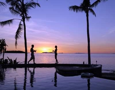 my-fiji-two-people-by-the-pool-at-sunset-at-treasure-island-resort