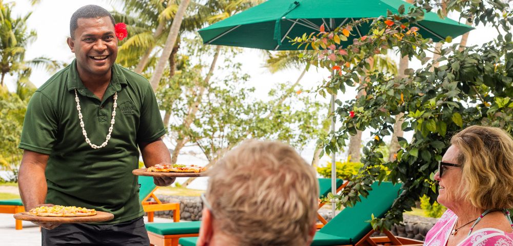 my-fiji-pizza-being-served-poolside-by-fijian-man-to-couple-at-waya-island-resort